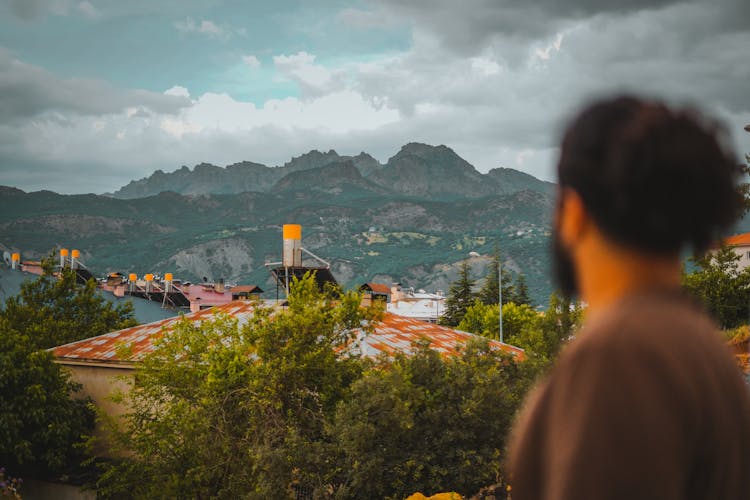 A Man Overlooking An Industrial Plant