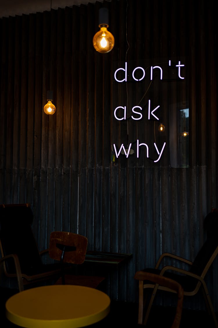 Illuminated Neon Signages On A Wooden Wall In A Restaurant