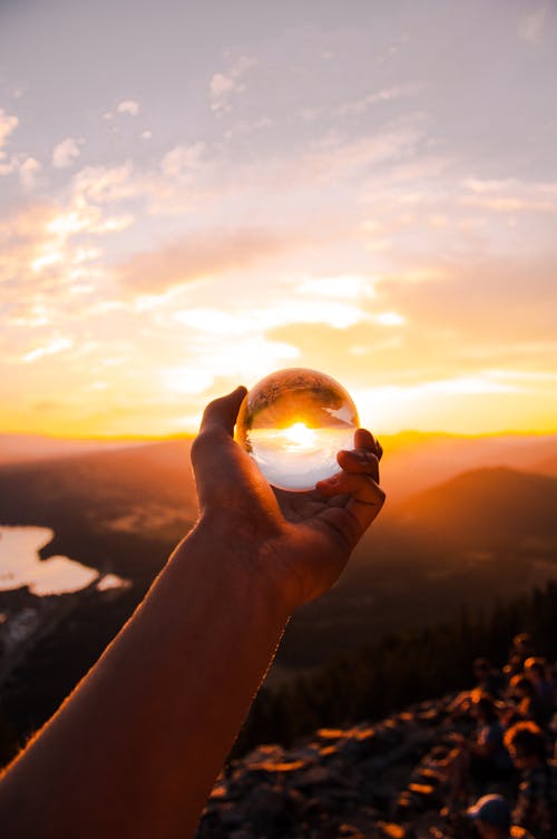 Free Person Holding a Glass Ball Stock Photo