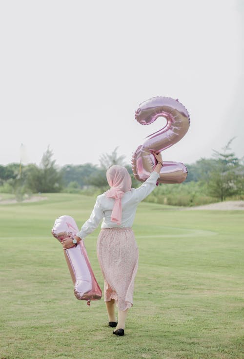 Woman Walking with Birthday Balloons