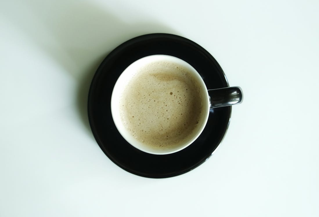 Flat Lay Photography of Latte Inside White Ceramic Mug