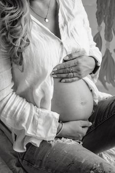Artistic black and white photo capturing the essence of pregnancy and motherhood. - Fotografer Sidoarjo