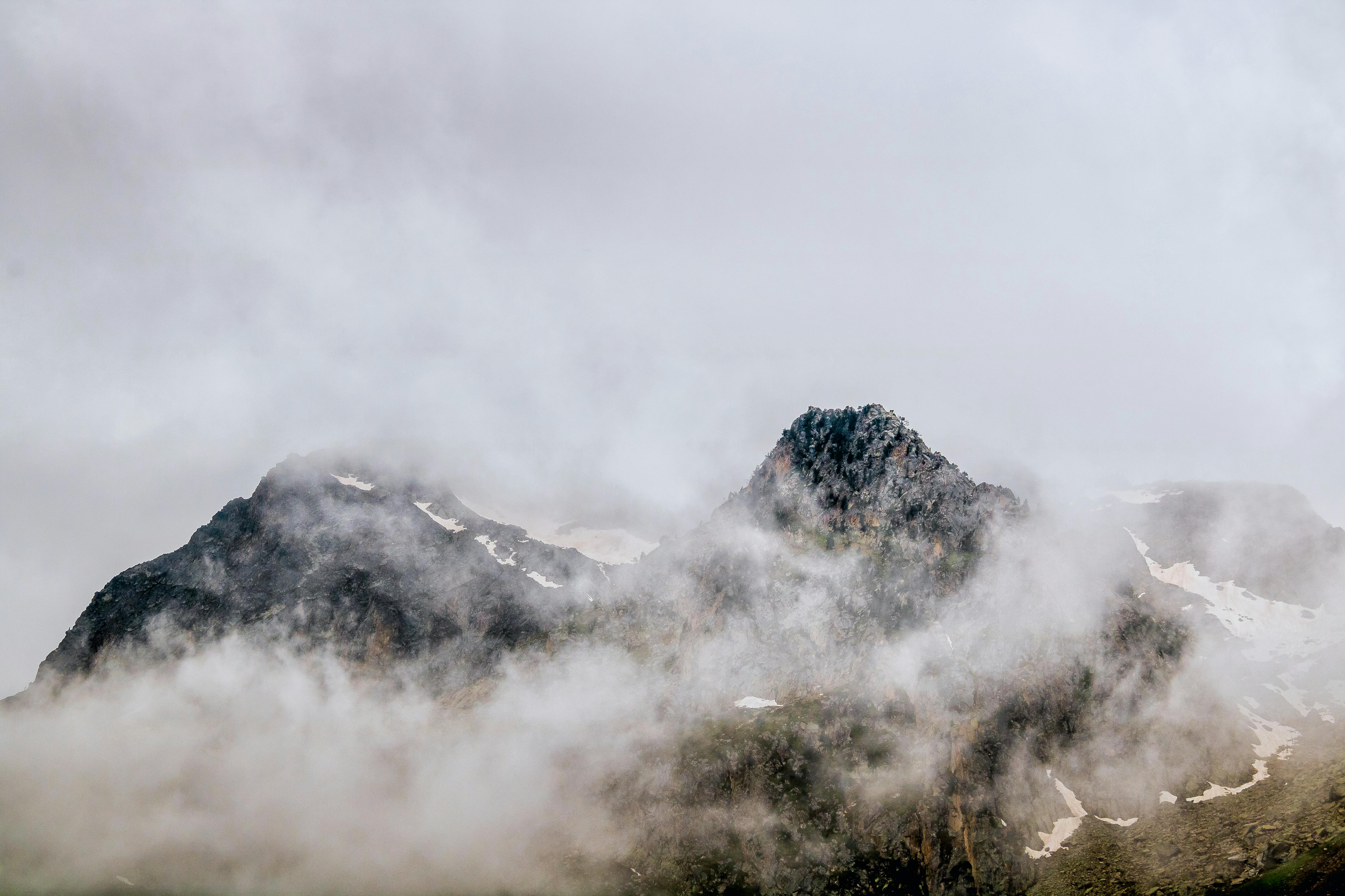 Captivating view of fog-covered mountains in the French Alps, showcasing natural beauty and tranquility.