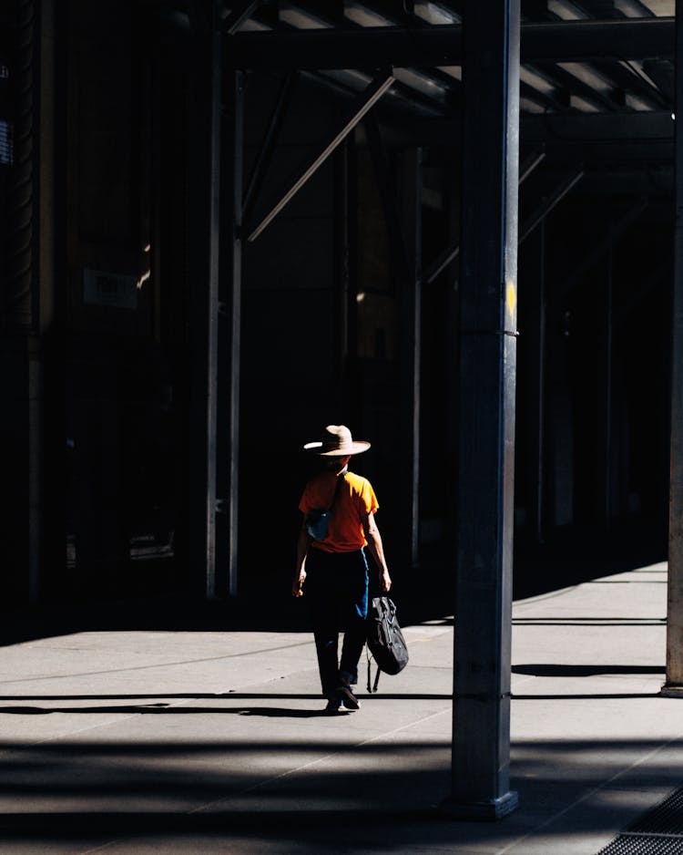 A Person Walking On The Sidewalk