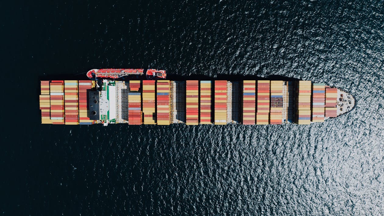 Directly Above a Fully Loaded Cargo Ship on a Sea 