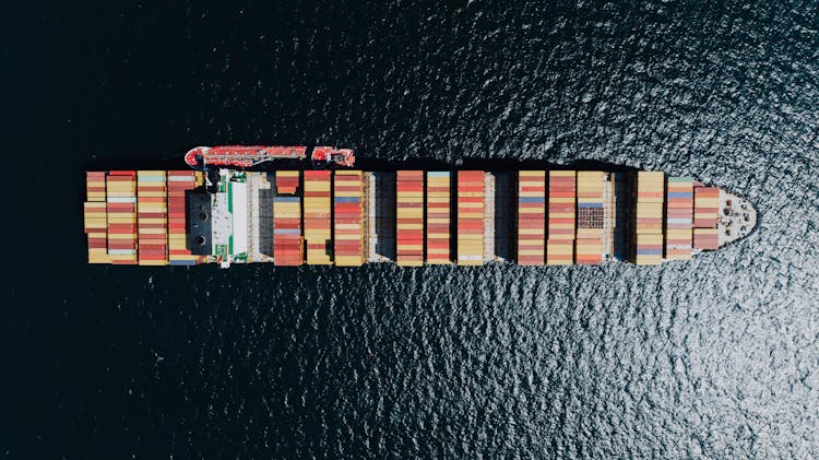 Directly Above A Fully Loaded Cargo Ship On A Sea 