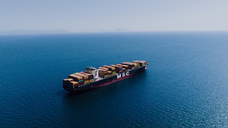 Fully Loaded Cargo Ship Sailing On Sea 