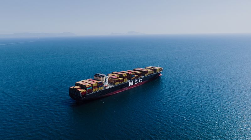 Fully loaded container ship crossing the open ocean