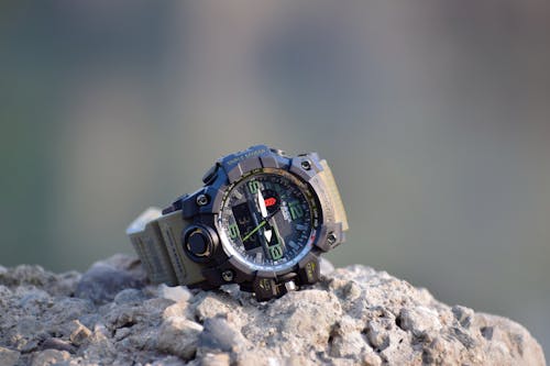 Silver and Black Chronograph Wristwatch on Rock