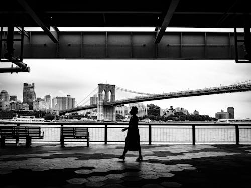 Free Silhouette of a Person Walking Under the Bridge Stock Photo