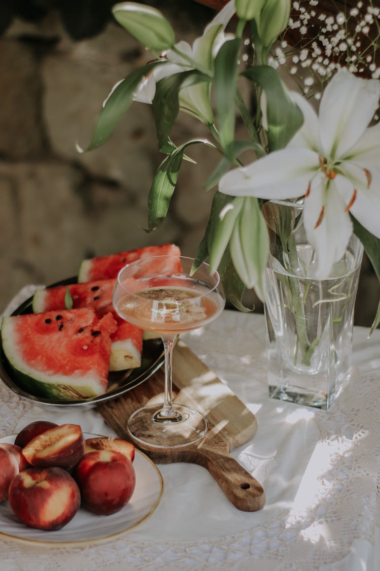 Summer Table With Watermelon, Peaches And Lily Flower