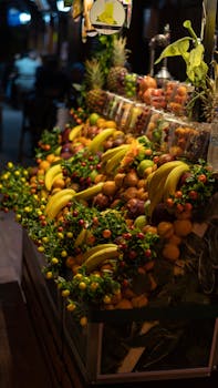 Colorful assortment of fruits at a street stand in Istanbul, Turkey, captured during nighttime.