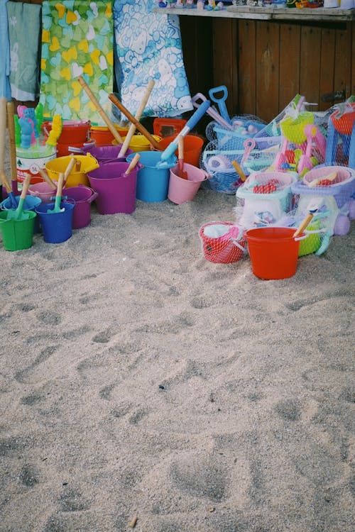 Free Assorted Plastic Cups on Sand Stock Photo