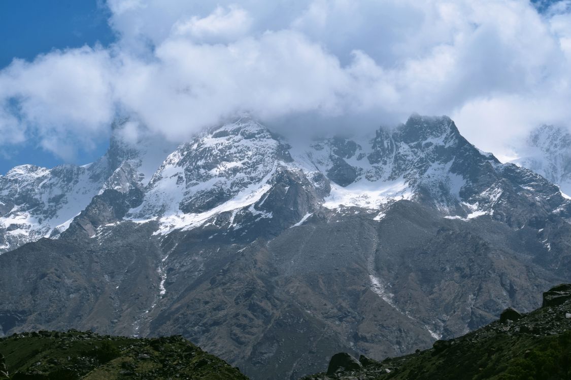A Snow Covered Mountain Under the Cloudy Sky · Free Stock Photo