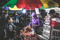 Woman Wearing Purple Hijab Selling Food