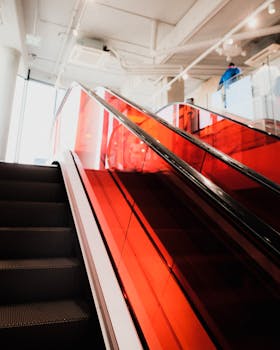 Vibrant red escalator in a modern indoor setting, perfect for contemporary designs.