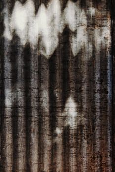 Close-up view of a grunge metal surface featuring light and dark patterns, ideal for backgrounds.