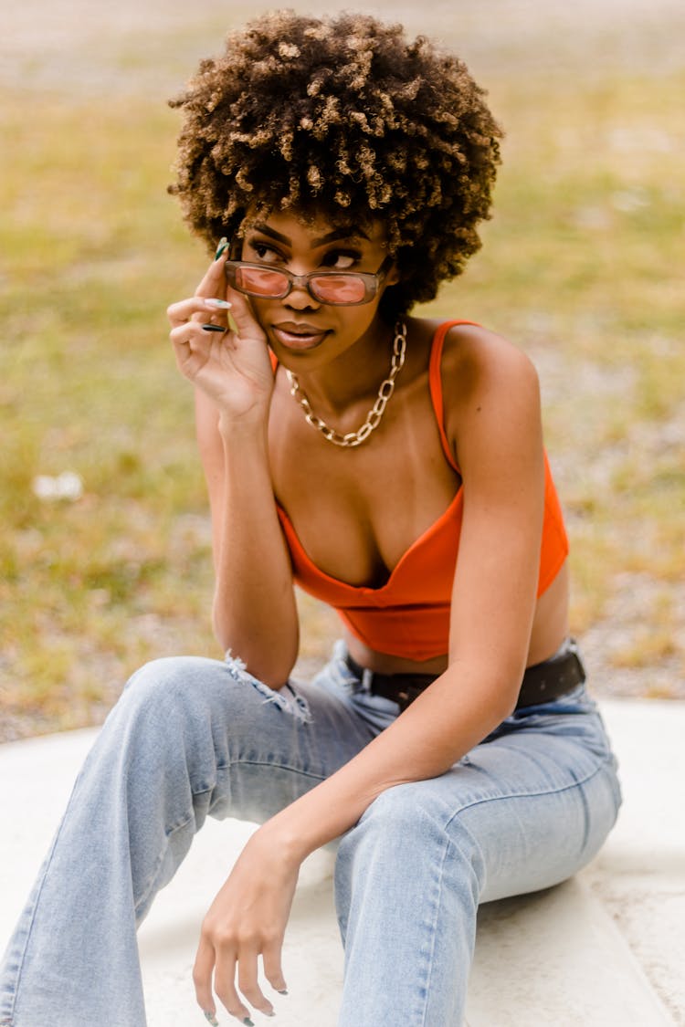 Sexy Woman Wearing Sunglasses Sitting On Ground