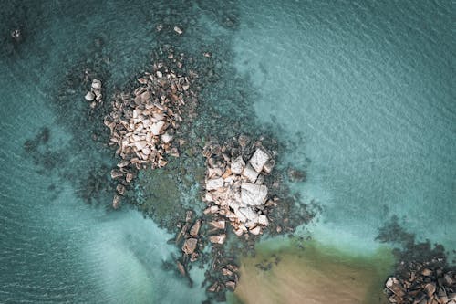 An Aerial Photography of a Rocky Shore on the Beach
