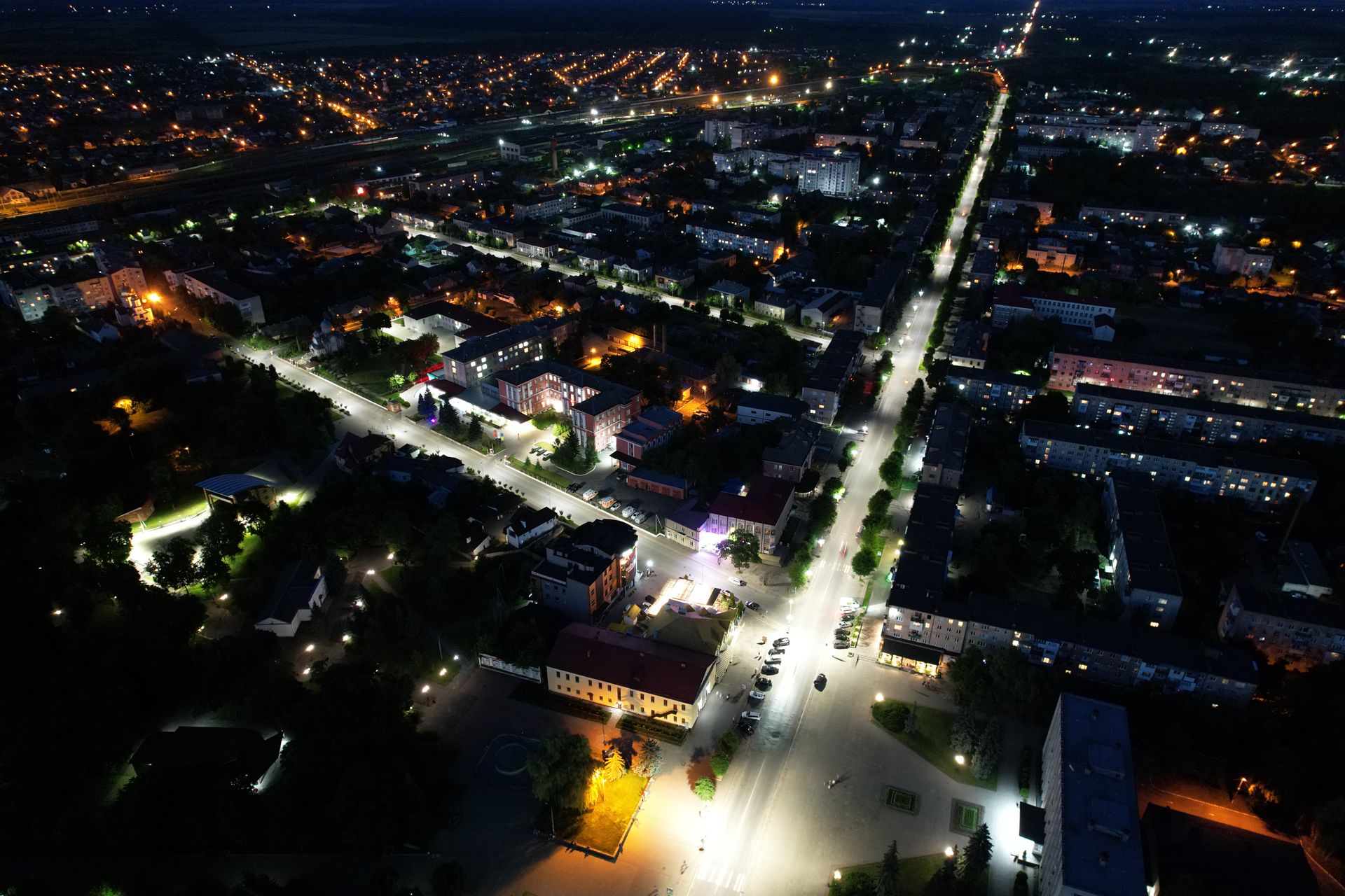 Discover the urban landscape of Kovel, Ukraine at night with its vibrant city lights from an aerial perspective.