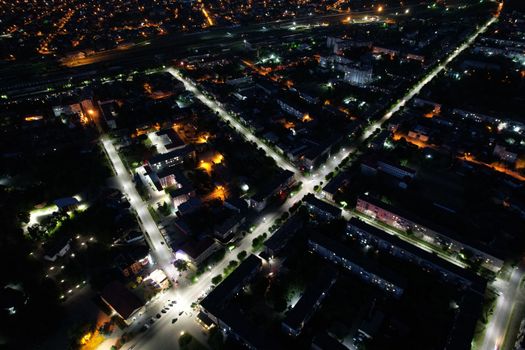Drone capture of Kovel, Ukraine at night showcasing illuminated streets and buildings.