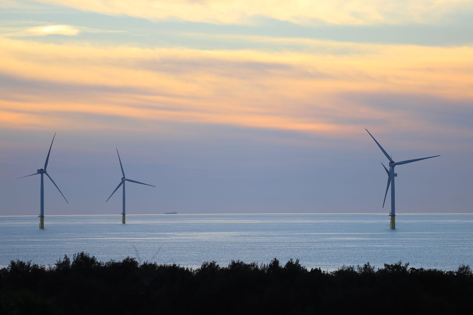 Offshore wind turbines at sunset