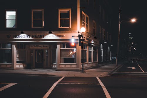 A Lamppost near a Building at Night