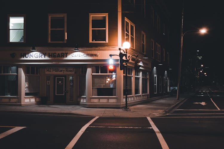 A Lamppost Near A Building At Night