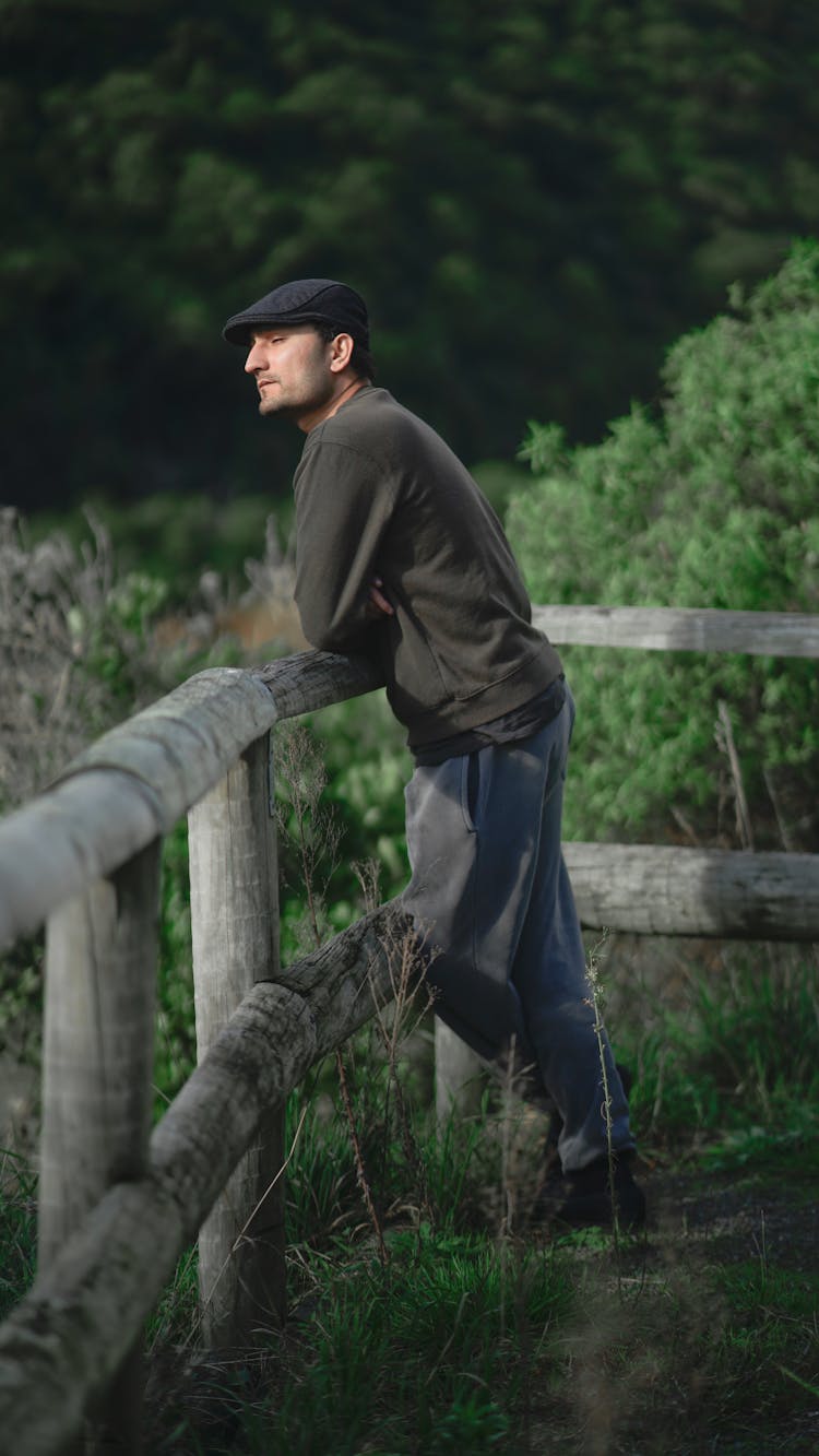 Man Near Wooden Fence in Nature Thinking