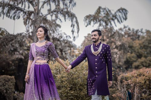 Fotobanka s bezplatnými fotkami na tému držanie za ruky, fialové oblečenie, indiánsky pár