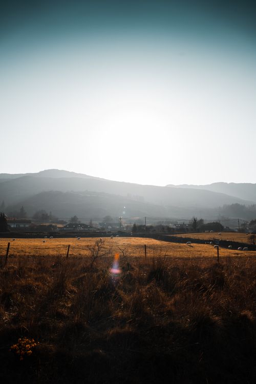 Free Beautiful sunrise over an Irish landscape with rolling hills and fields. Stock Photo