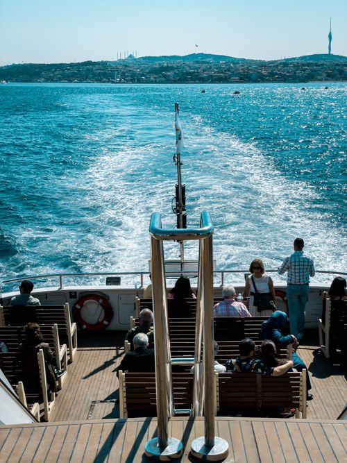 Free Passengers enjoy a sunny ferry ride on the Bosphorus in Istanbul, Turkey. Stock Photo
