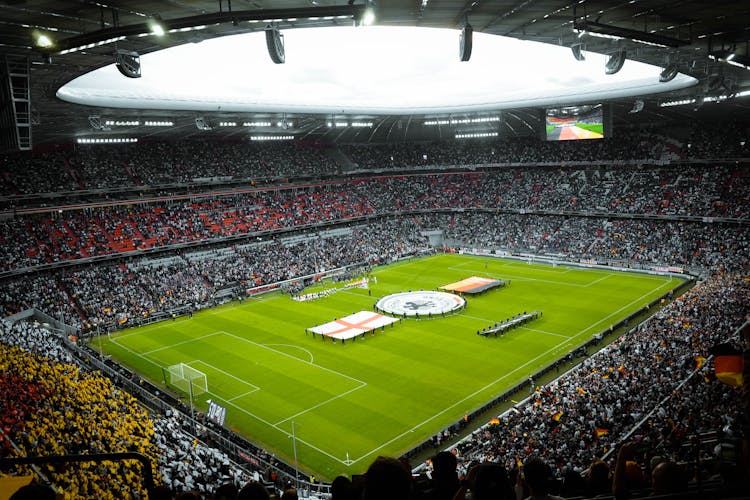 People Watching Soccer Game On A Stadium