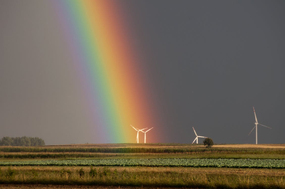 Free Landscape Photography of Field With Wind Mill With Rainbow Stock Photo