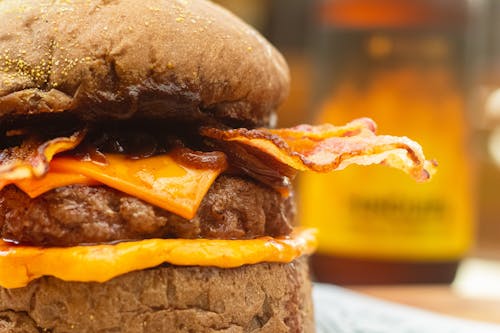 A Close-up Shot of a Cheeseburger with Bacon