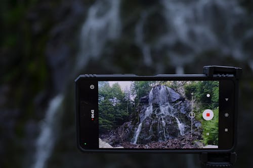 A Smartphone Recording a Video of a Waterfall