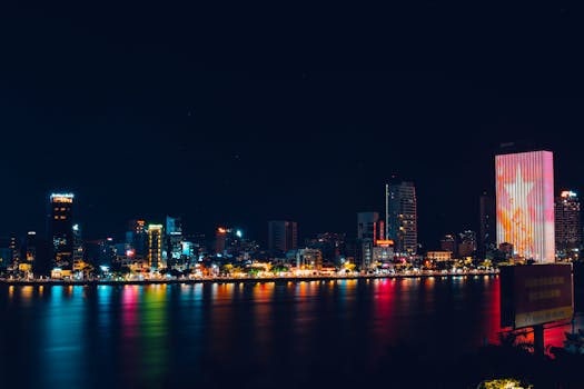 Breathtaking night scene of Da Nang skyline with city lights reflecting on the Han River.