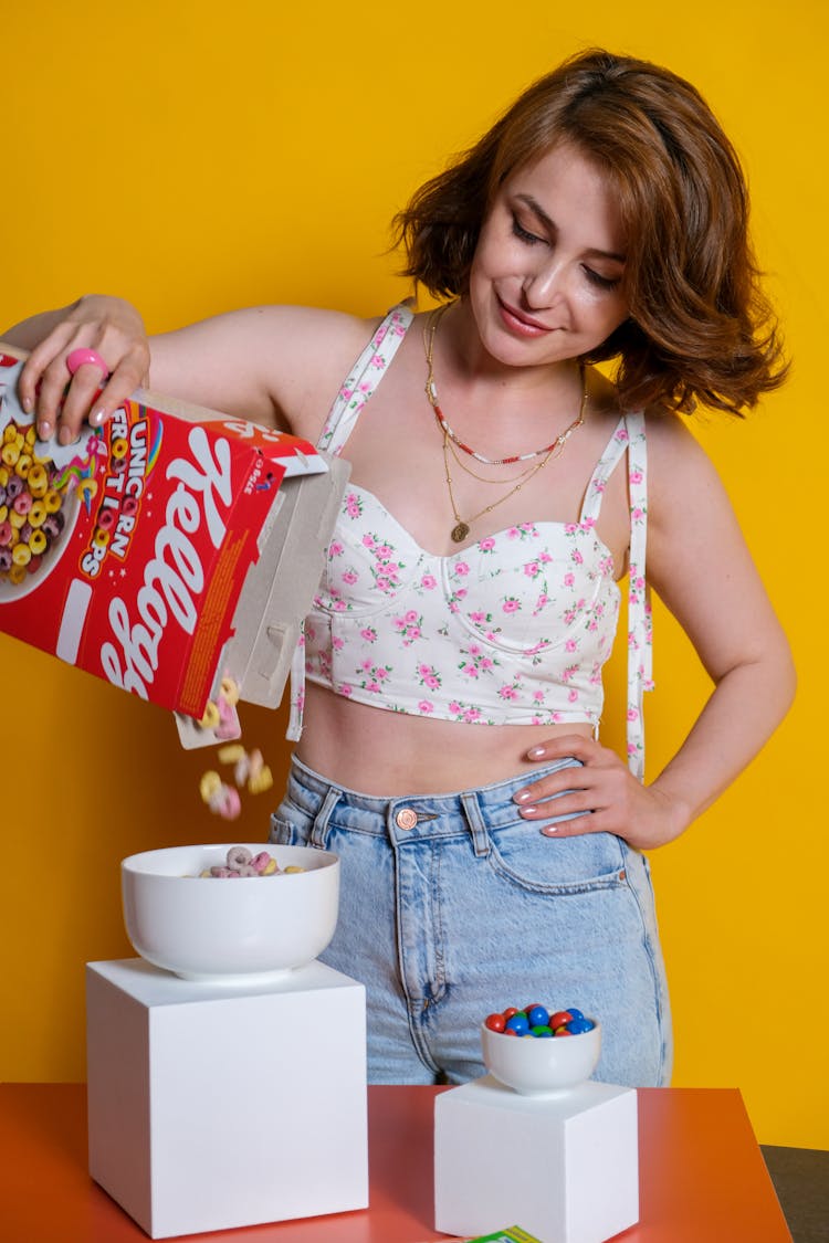 Woman Putting Cereal Into A Bowl 