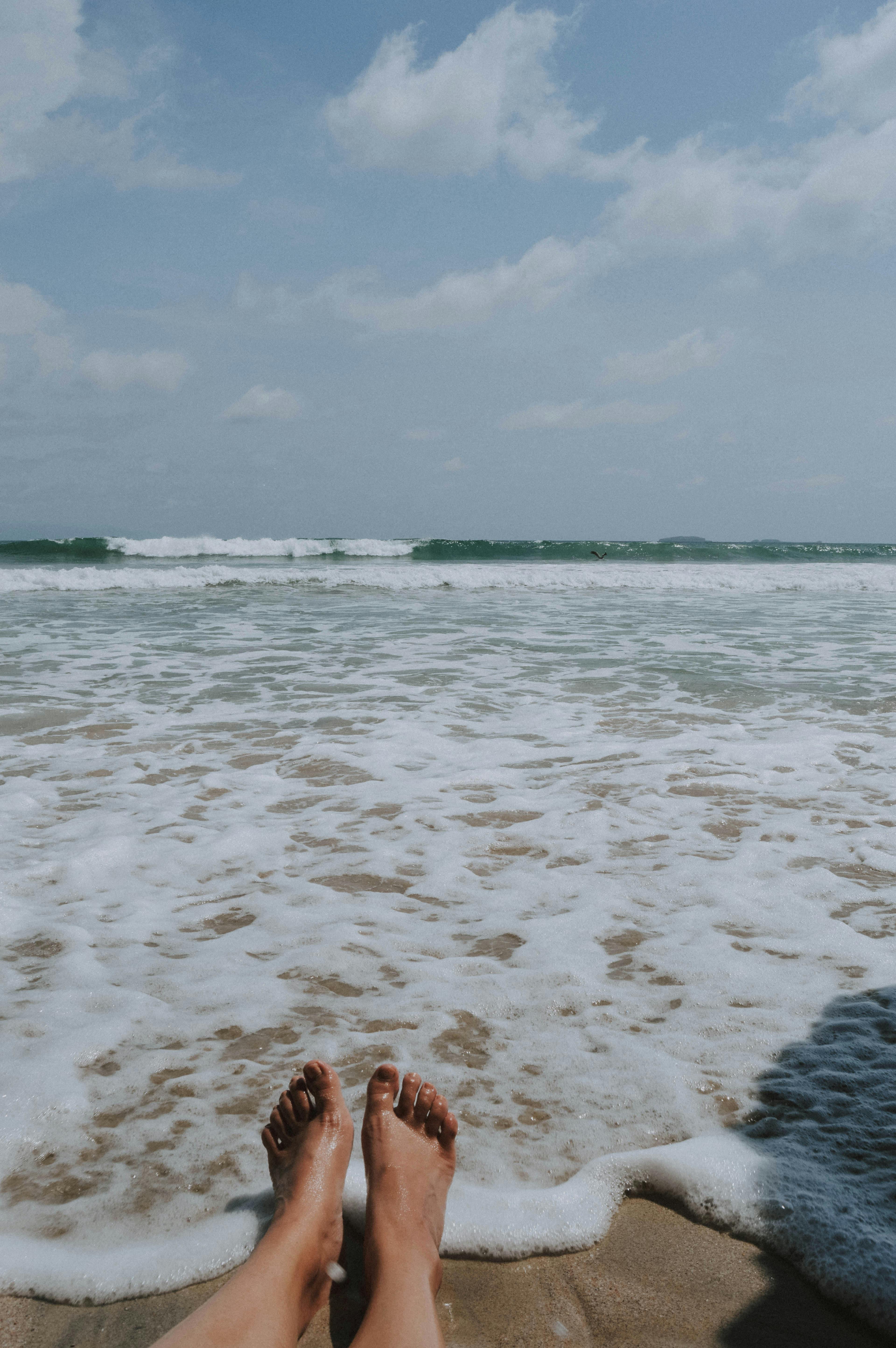 person sitting on brown seashore