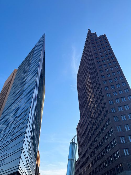 Free Low-angle shot of modern skyscrapers in a city with a clear blue sky. Stock Photo