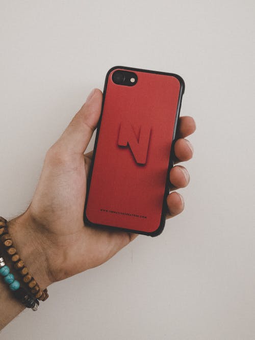 Person Holding Black Iphone 7 and Red Case Screenshot