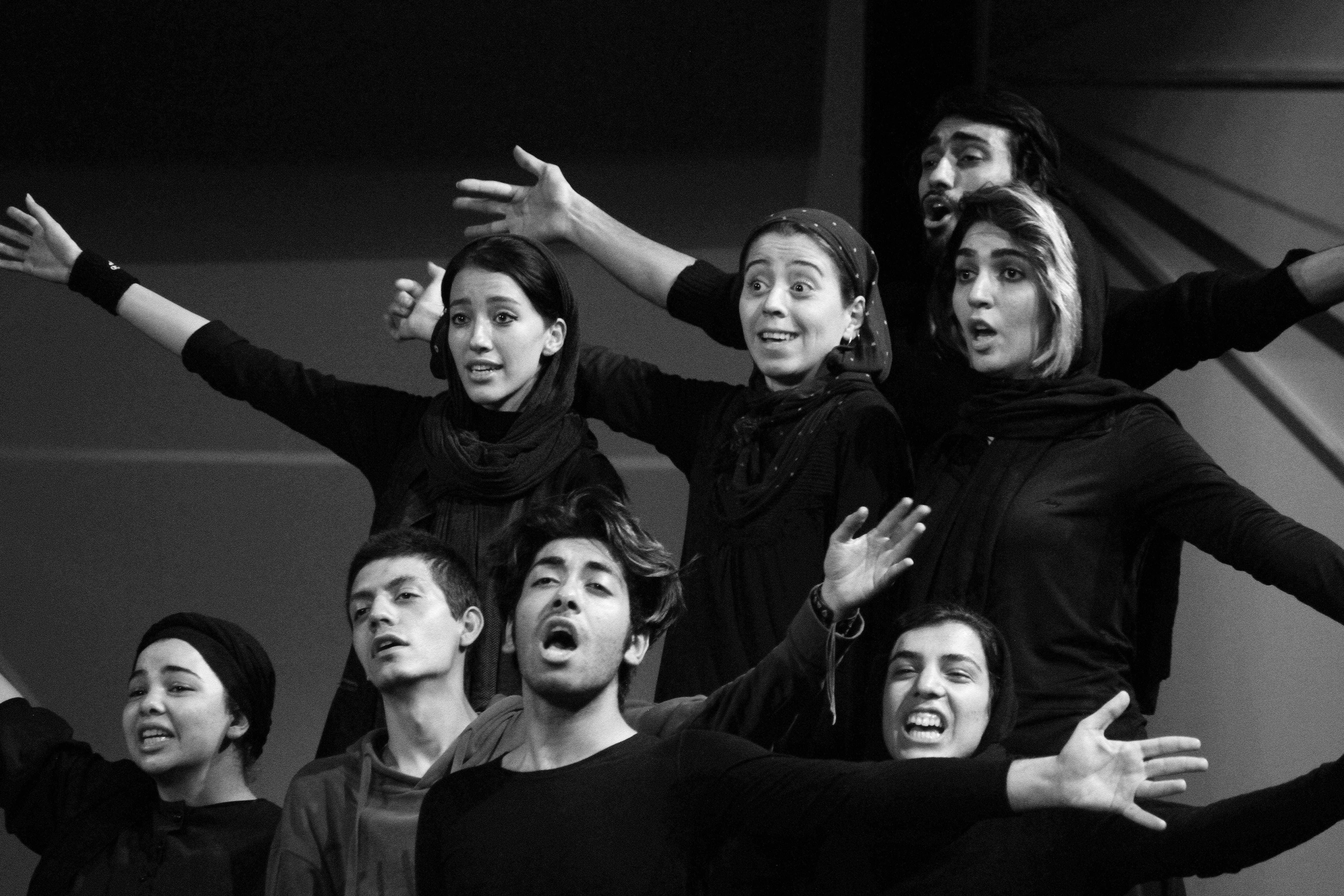 Free A vibrant group showcasing expressive dance movements in a monochrome setting. Stock Photo