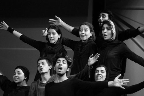 Free A vibrant group showcasing expressive dance movements in a monochrome setting. Stock Photo