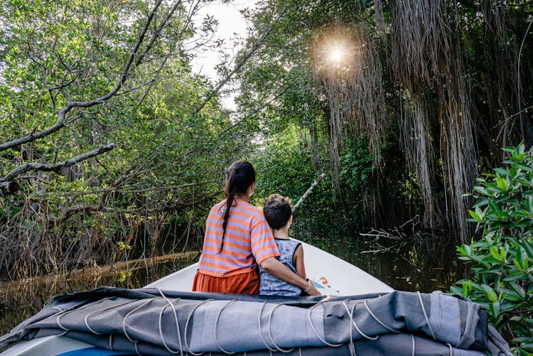 Backview Of Mother And Son On A Boat 