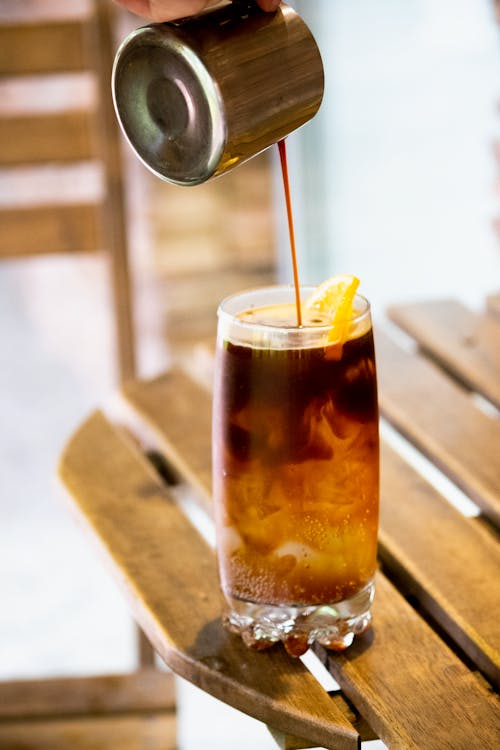 Pouring of Espresso on a Cold Drink 