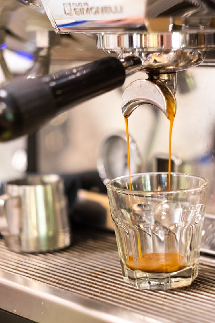 Pouring Of Espresso On A Shot Glass