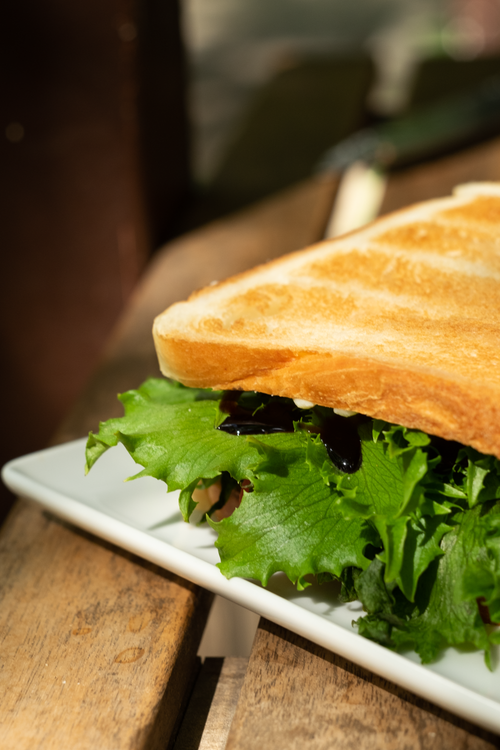 Free Crisp sandwich with fresh greens served on toasted bread, perfect for a healthy snack. Stock Photo