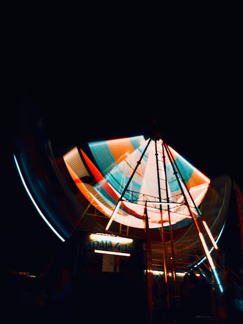 Long Exposure Photo of an Illuminated Ferris Wheel 