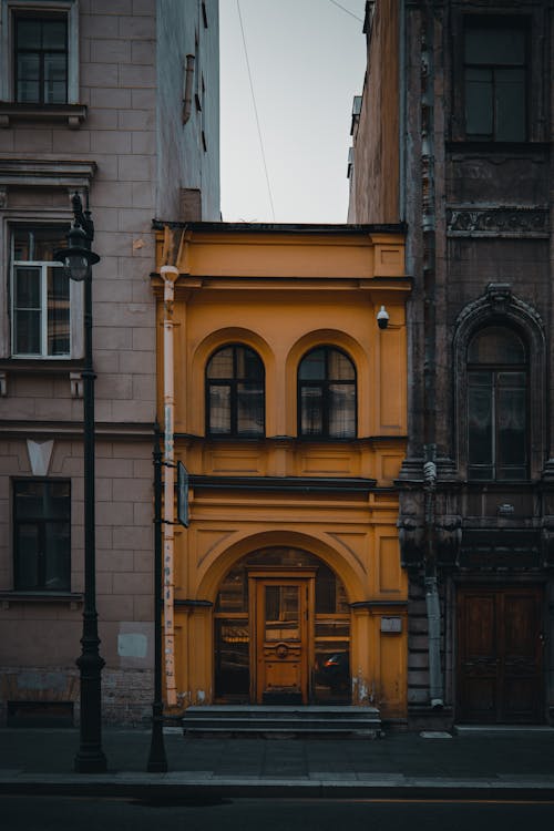 Orange Building between Tall Buildings 