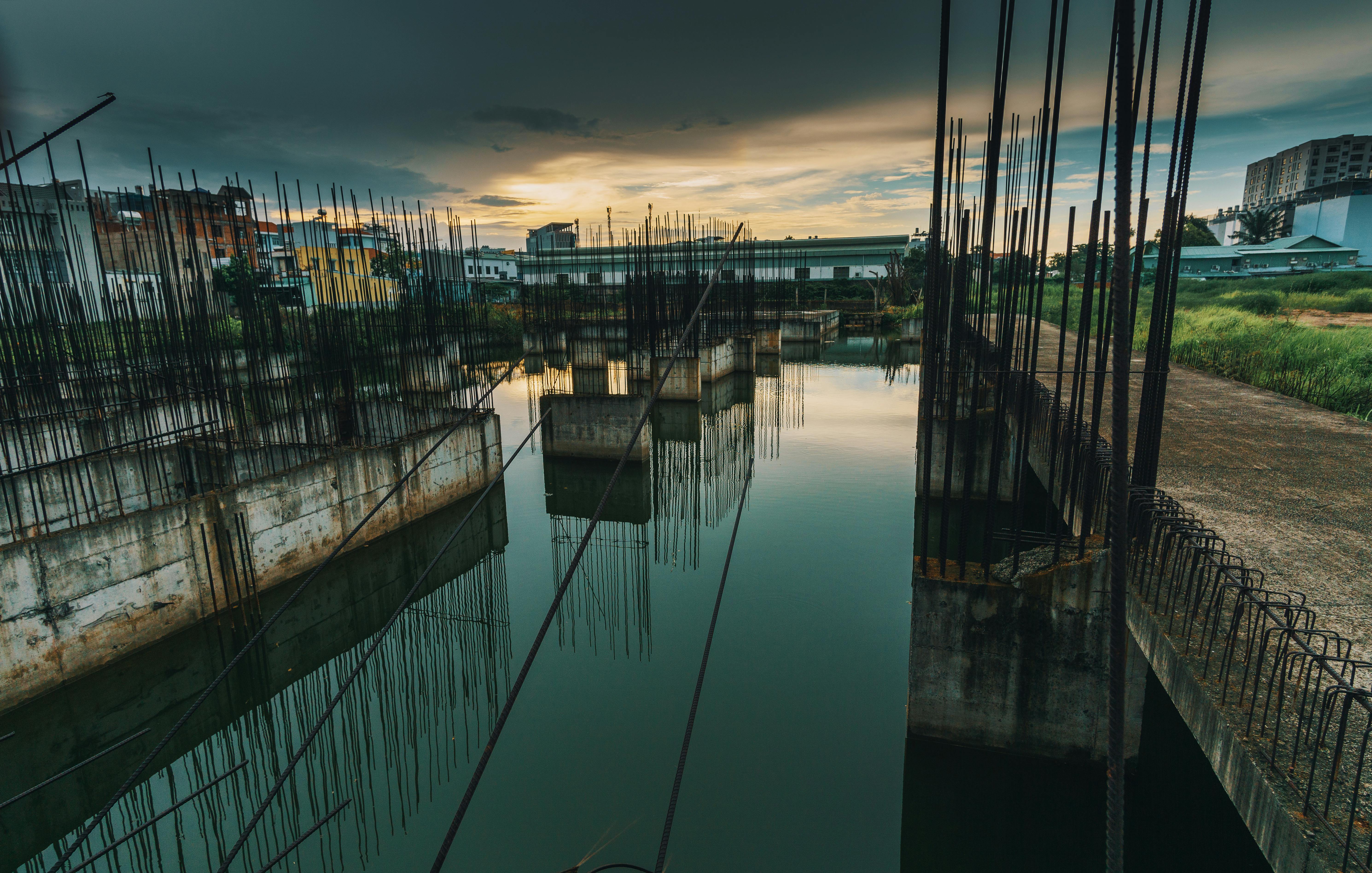 photo of metal bars on water under dark sky